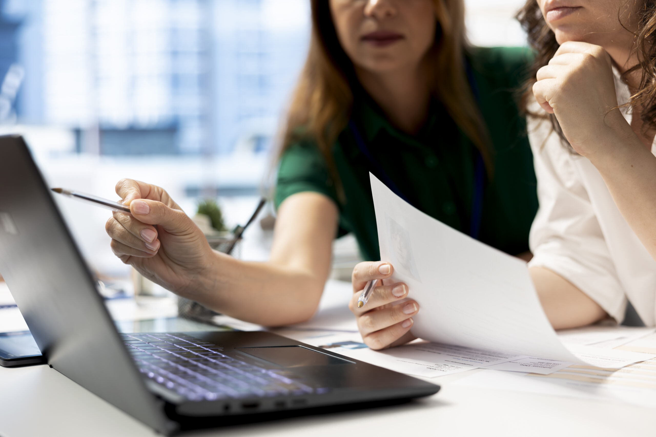 hr coworkers using laptop preemployment assessments scaled