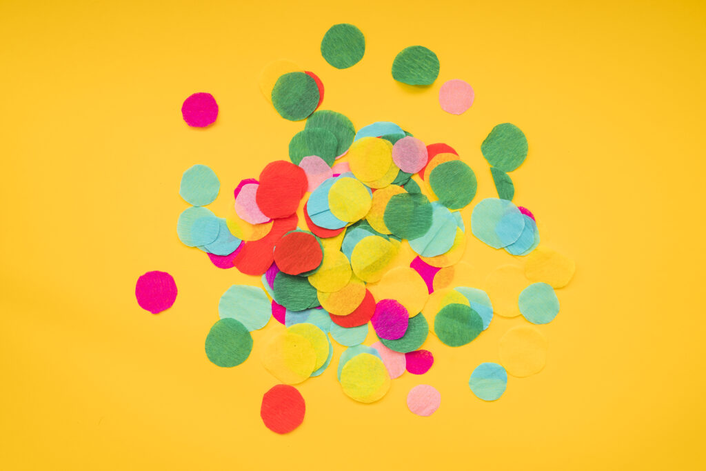 round colorful confetti yellow background